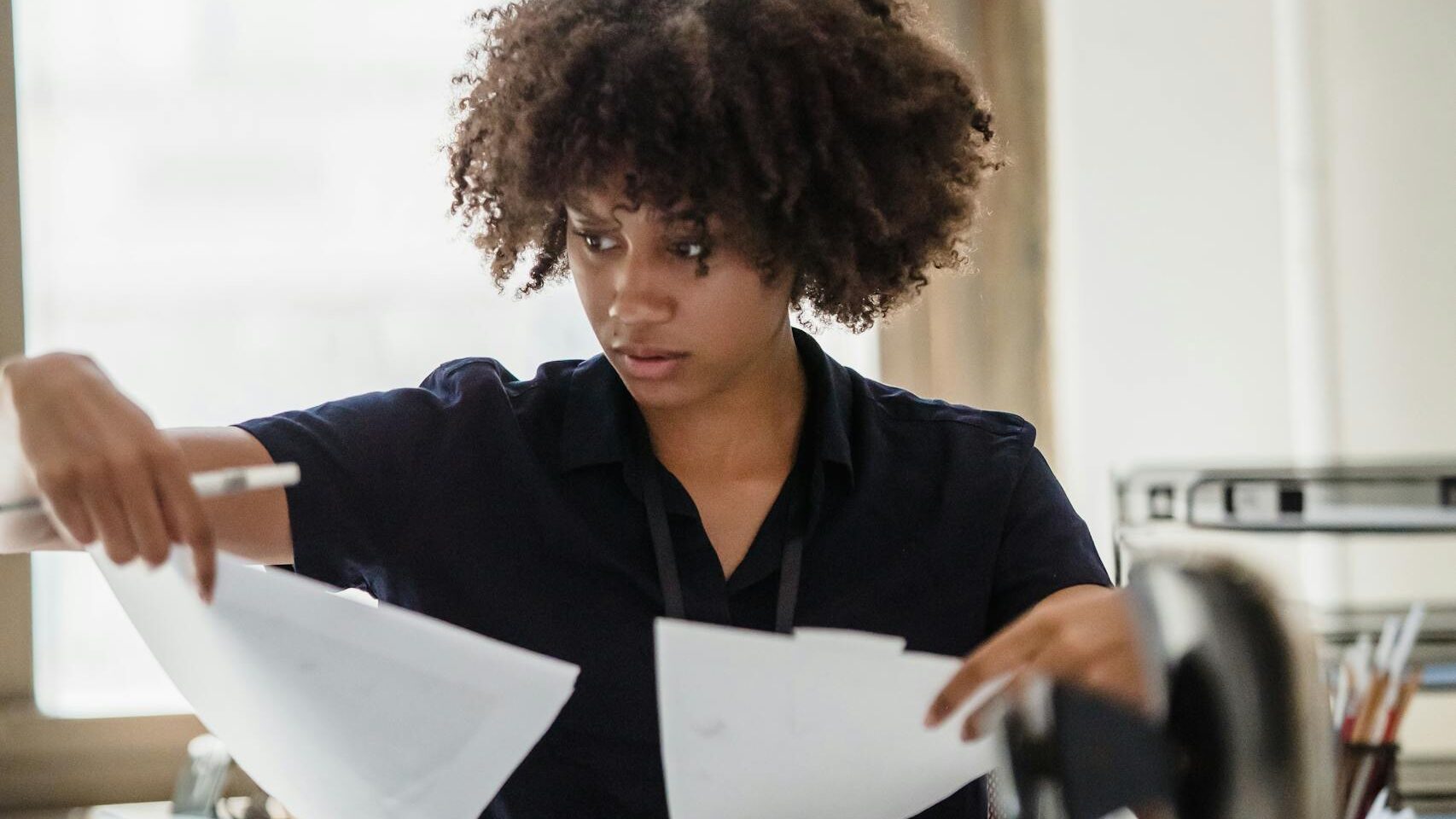 Woman Comparing Documents in an Office